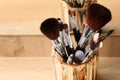 Set of professional makeup brushes near mirror on wooden table, closeup Royalty Free Stock Photo