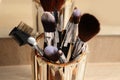 Set of professional makeup brushes near mirror on wooden table, closeup Royalty Free Stock Photo