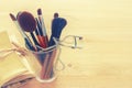 Set of professional makeup brushes on wooden table. Royalty Free Stock Photo