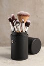 Set of professional makeup brushes on wooden table against light grey background Royalty Free Stock Photo