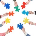 Set puzzle pieces in people hands in circle Royalty Free Stock Photo