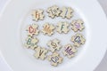 Set of puzzles on a plate with 13 essential micronutrients with multicolored inscriptions icons. Fe, Zn, I, Cu, Me, F