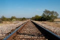 A set of railroad tracks disappearing on the distant horizon