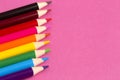 Set of Rainbow Colored Pencils on a Bright Pink Background Royalty Free Stock Photo