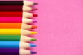 Set of Rainbow Colored Pencils on a Bright Pink Background Royalty Free Stock Photo