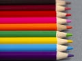 Set of Rainbow Colored Pencils on a Gray Background Royalty Free Stock Photo