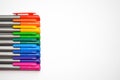 Set of rainbow colored pens, exactly lying straight in the left side of the photo with copyspace Royalty Free Stock Photo