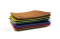 Set of rainbow colorful felt samples, brown top, multicolor, bright, closeup on white background