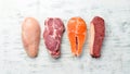 Set of raw meat steaks salmon, beef and chicken on a white wooden background.