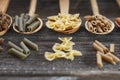 A set of raw pastas on spoons on a wooden table Royalty Free Stock Photo