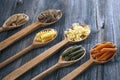A set of raw pastas on spoons on a wooden table Royalty Free Stock Photo