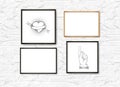 Set of Realistic Light and Dark Wooden Picture Frames on a White brick Wall with posters. Royalty Free Stock Photo