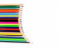 Set of realistic pencil crayons arranged in a waved pattern on a white background Royalty Free Stock Photo