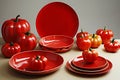 Set of red ceramic dishes in the shape of a tomato on a gray-beige background Royalty Free Stock Photo