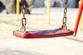 Set of red chain swings on modern kids playground Royalty Free Stock Photo