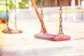 Set of red chain swings on modern kids playground Royalty Free Stock Photo