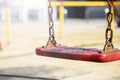 Set of red chain swings on modern kids playground Royalty Free Stock Photo