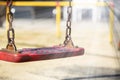 Set of red chain swings on modern kids playground Royalty Free Stock Photo