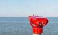 A set of red coin operated binoculars on the pier Royalty Free Stock Photo