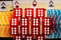 A set of red dice and blue yellow casino chips on the background of four of a kind of four aces on gaming table in