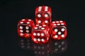 Set of red game cubes, on a black background, with reflection Royalty Free Stock Photo
