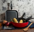 a set of red pans with vegetables Royalty Free Stock Photo