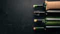 Set of red and white wine in bottles and glasses. Grape. On a black wooden background. Free space for text. Royalty Free Stock Photo