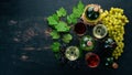 Set of red and white wine in bottles and glasses. Grape. On a black wooden background. Free space for text.