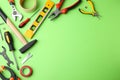 Set of repair tools on green background, flat lay. Space for text Royalty Free Stock Photo