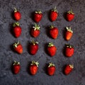 Set of ripe red strawberries on dark background. Strawberry pattern. Dark low key photo. Square flat lay composition Royalty Free Stock Photo