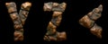 Set of rocky letters Y, Z, and symbol left angle bracket. Font of stone on black background. 3d