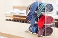 Set of rolled up neck ties on plastic shelf