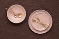 A set of round beige plates of different sizes on the table, top view. Gold cutlery and serving utensils. Modern trendy ceramic Royalty Free Stock Photo