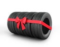 A set of rubber tires with ribbon and bow.