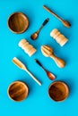 Set of rustic wooden tableware - bowls and utensils on blue background top view pattern