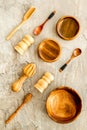 Set of rustic wooden tableware - bowls and utensils on grey background top view pattern