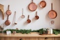 Set of saucepans hanging in kitchen. Hanging Copper kitchen utensil on the white wall. Different kind of vintage copper cookware, Royalty Free Stock Photo