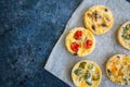 Set of savory mini tarts on a baking paper. Vegetable quiches wi Royalty Free Stock Photo