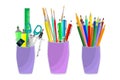 Set of school or office cups with stationery supplies isolated on a white background.