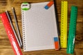 Set of school stationery supplies. Blank notepad, rulers, pencils, erasers and sharpener on wooden desk. Top view Royalty Free Stock Photo