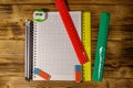 Set of school stationery supplies. Blank notepad, rulers, pencils, erasers and sharpener on wooden desk. Top view Royalty Free Stock Photo