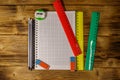 Set of school stationery supplies. Blank notepad, rulers, pencils, erasers and sharpener on wooden desk. Top view Royalty Free Stock Photo