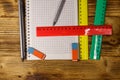 Set of school stationery supplies. Blank notepad, rulers, pencils, erasers and sharpener on wooden desk. Top view Royalty Free Stock Photo