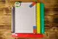 Set of school stationery supplies. Blank notepad, rulers, pencils, erasers and sharpener on wooden desk. Top view Royalty Free Stock Photo