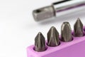 Set of screwdriver bits with screwdriver in the background Royalty Free Stock Photo