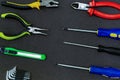 Set screwdriver row symmetrical green knife construction pliers plastic on a dark background base design