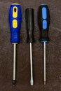 Set of screwdrivers three hand-held fixing tools home repairman on dark background design base