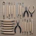 A set of sculpting tools arranged neatly on a textured burlap surface. The assortment includes Royalty Free Stock Photo
