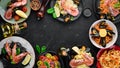 A set of seafood dishes on a black background. Pasta, bulgur, rice, couscous.