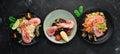 A set of seafood dishes on a black background. Pasta, bulgur, rice, couscous.